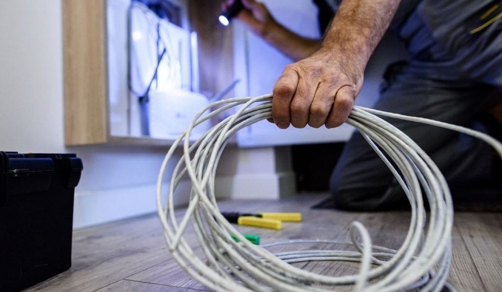 Repairman fixing the ethernet cable 