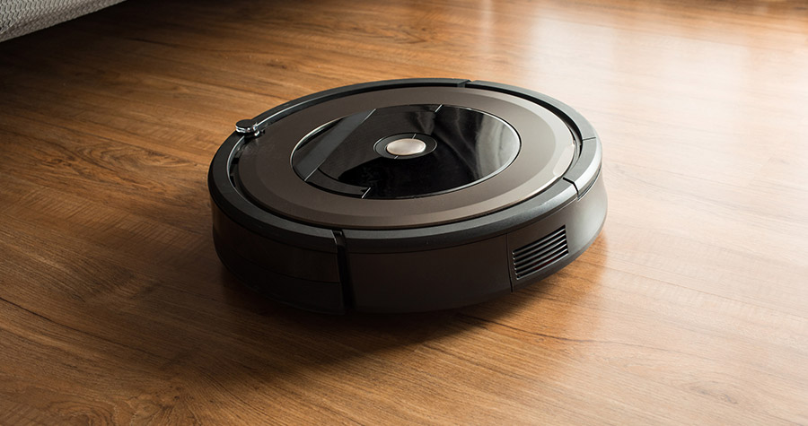 Robot vacuum cleaner on a wooden laminate floor