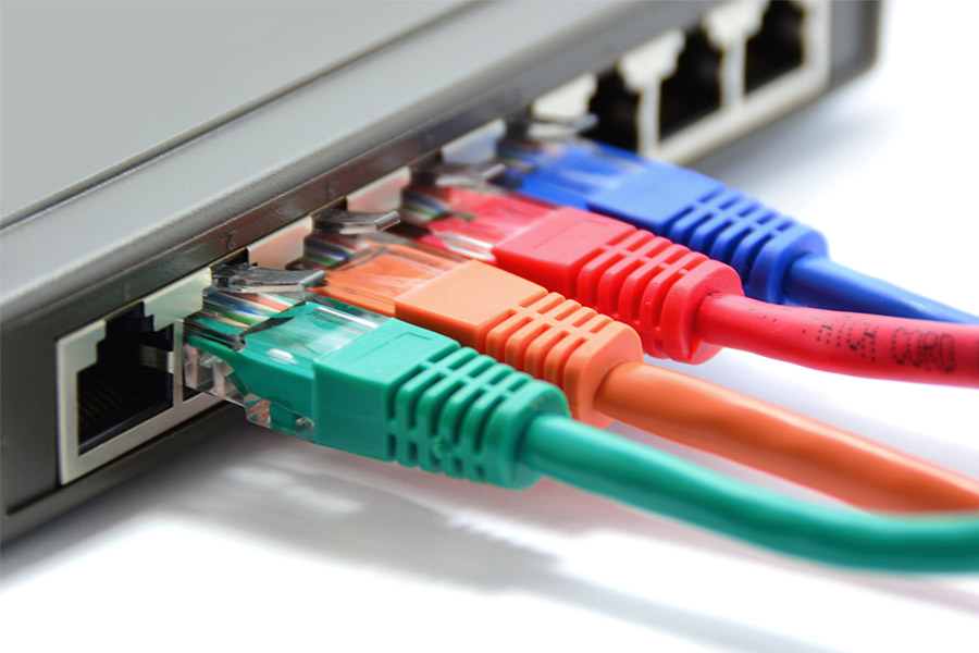 Network switch with different colored Ethernet cables connected to it