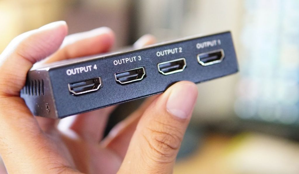 Person holding an HDMI Splitter