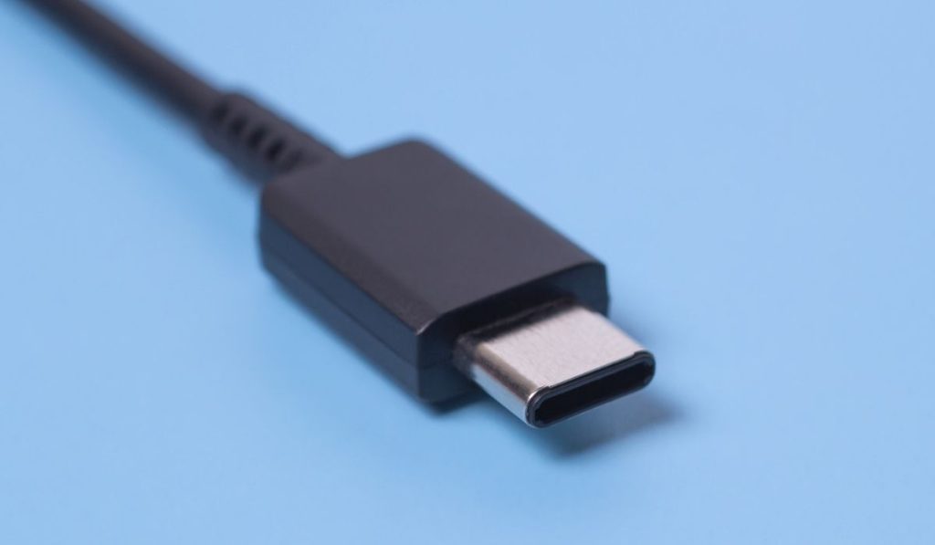 Close up photo of usb type c connector on blue blurred background