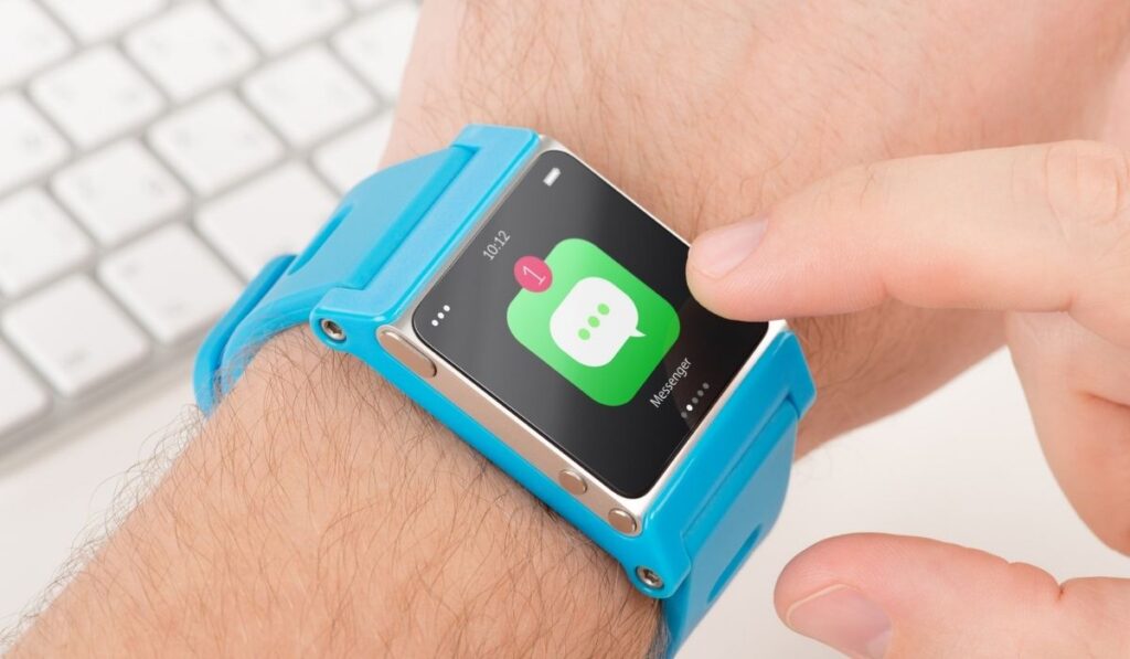 Finger taps messenger icon on blue smart watch