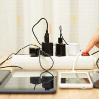 Man is turning off power adapters for mobile phones and tablet