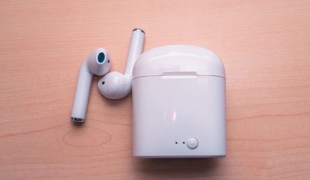 airpods with the case are on the desk