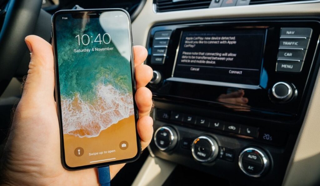 Man Connecting to Apple cArPlay the new iphone X 10 by Apple 
