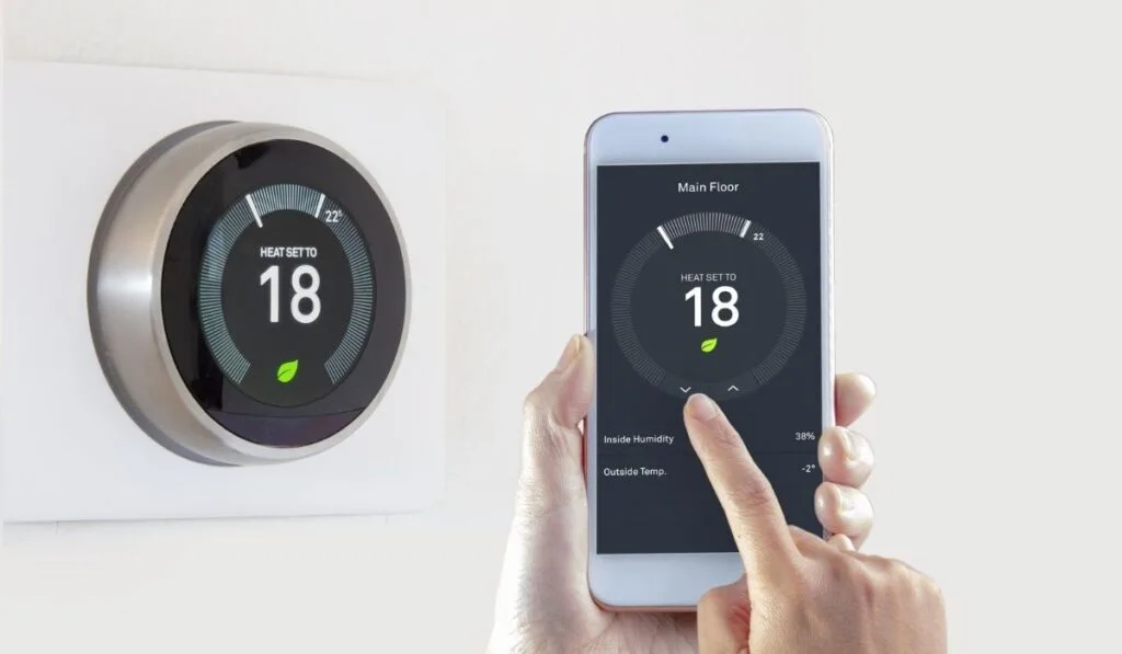 Smart Thermostat with a person saving energy with a smart device on a white background