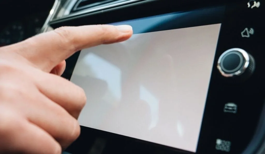 Woman pressing button on the white computer dashboard screen