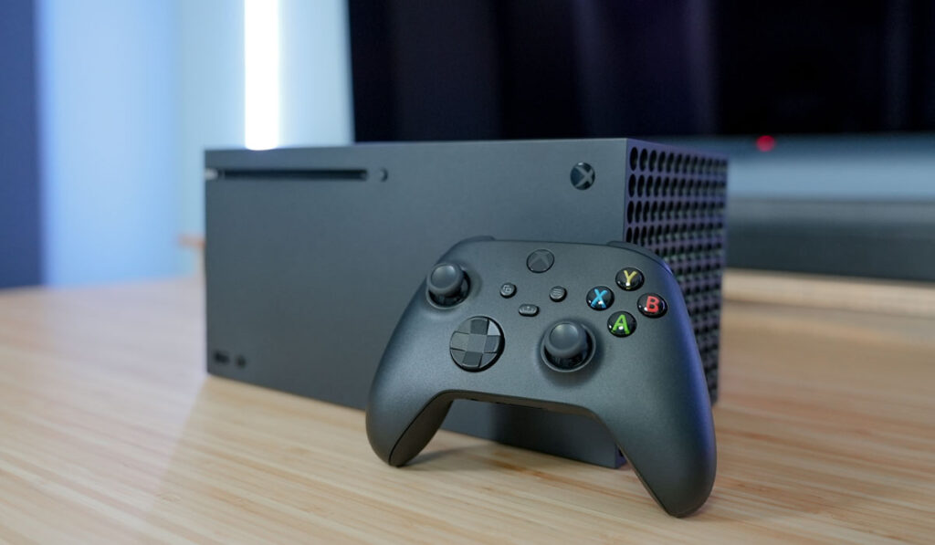 Xbox Series X on a wooden table with LED lights in the background