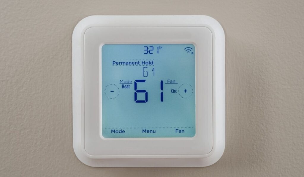 Photograph of a modern thermostat for heating and cooling