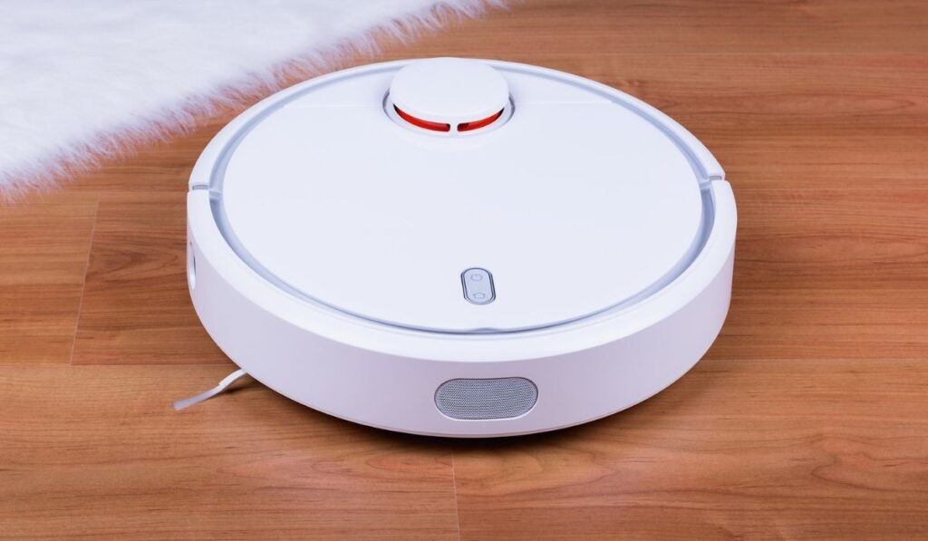 Vacuum cleaner robot on laminate wood floor