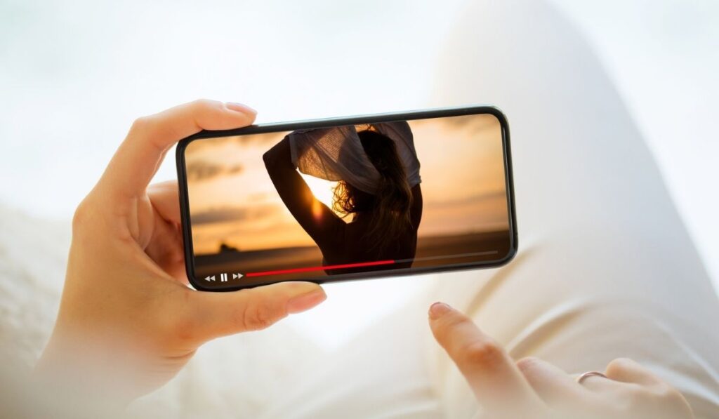 Woman watching video on mobile phone 