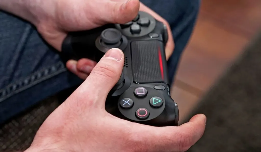 Man playing focus on game controller 