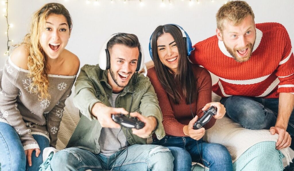 Millennial friends playing video games online with headset