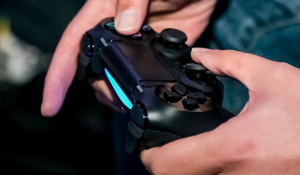 Play Station PS4 controller in a gamers hands