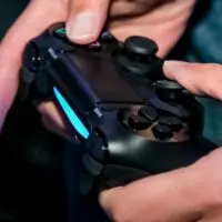 Play Station PS4 controller in a gamers hands