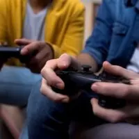 Two multiethnic teenage boys playing computer games at home