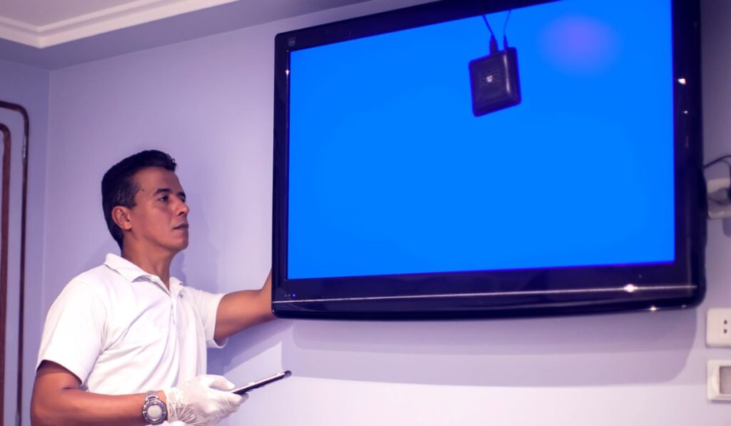 A man worker fix tv with blue screen