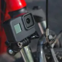 Action camera mounted on the handlebar of a bicycle