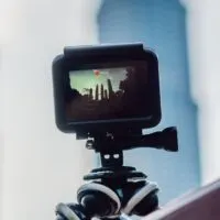 Action camera on a tripod records a video of the time-lapse of a big city -