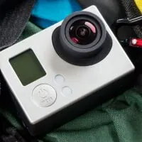 An action camera in waterproof case and small tripod