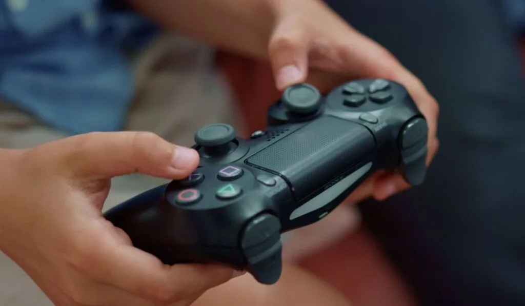 Boy hands playing game with gamepad