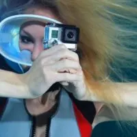 Female scuba diver with action camera