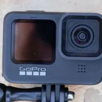 GoPro Hero 9 Black lies on a stone floor under the sun