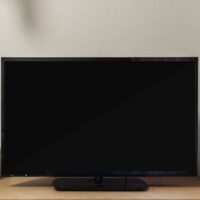 LED TV with blank black screen on built in shelf in living room