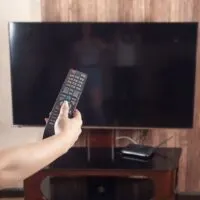 Woman using tv remote controller