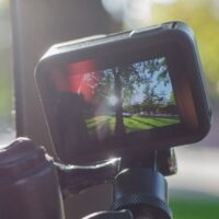 Action camera mounted on the handlebar of a bicycle