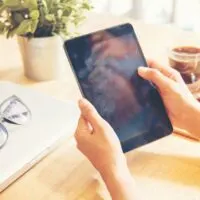 Beautiful business working woman using Ipad