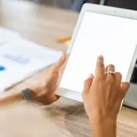 Lifestyle with modern woman using tablet or Ipad with hand holding touchscreen