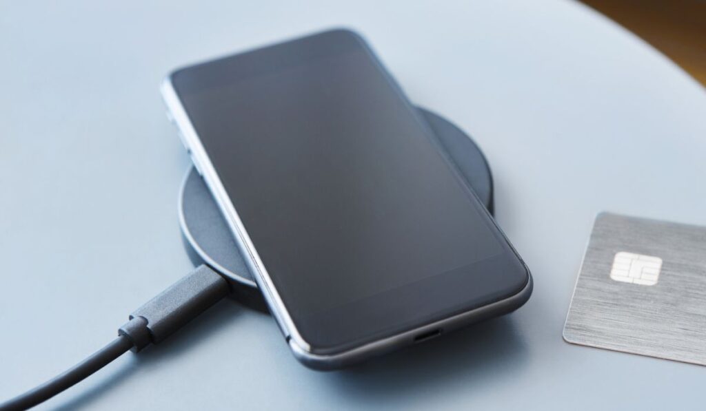 Wireless charging of modern black smartphone 