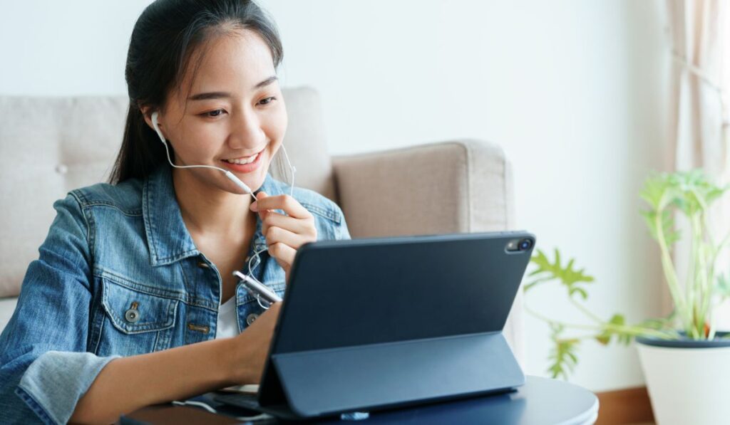 Asian women is conducting video conference with her co-worker 