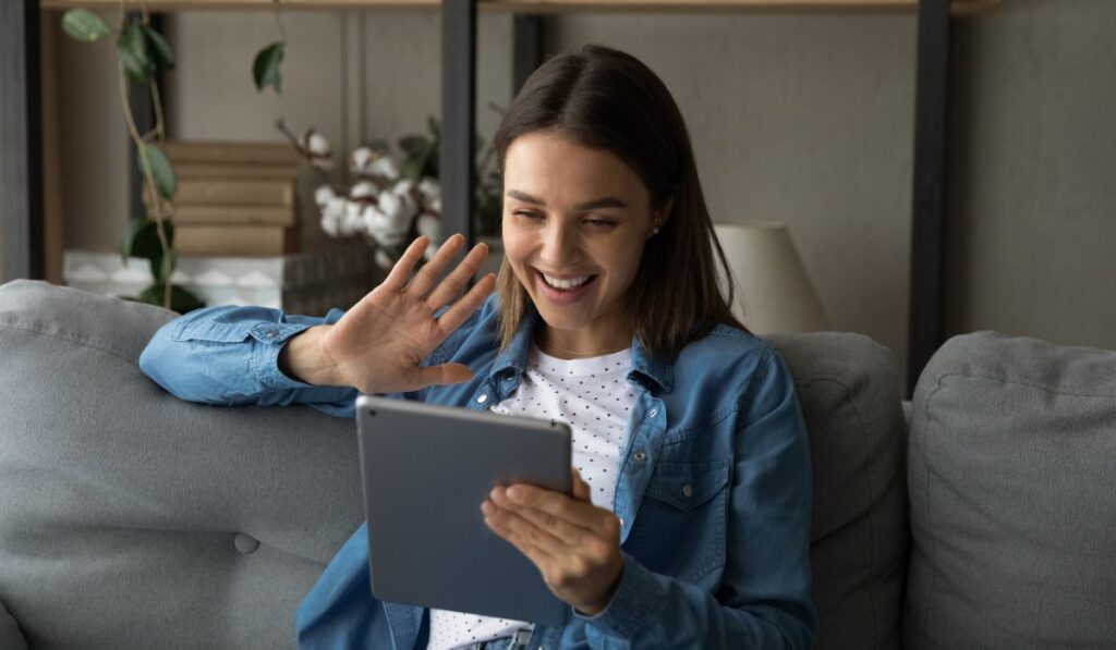 Happy young woman talk on video call on tablet 