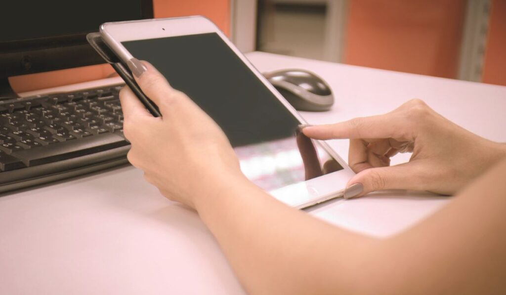 Woman play Ipad black and white background office 