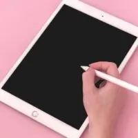 Woman using Apple iPad with stylus pen