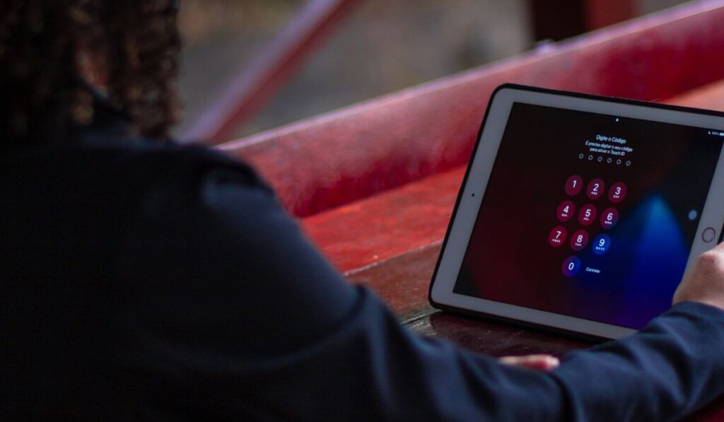 A Person Looking at a Tablet Screen with Password