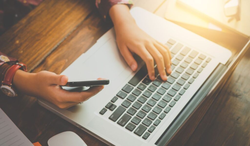 Businessmen are using their mobile to work with a laptop