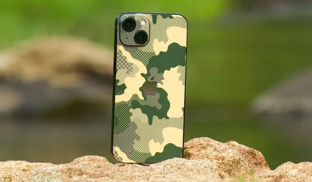 Close-Up Shot of a Mobile Phone on Brown Rock