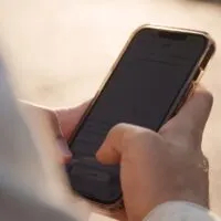 Close-up of men`s hands with a phone in their hands typing sms