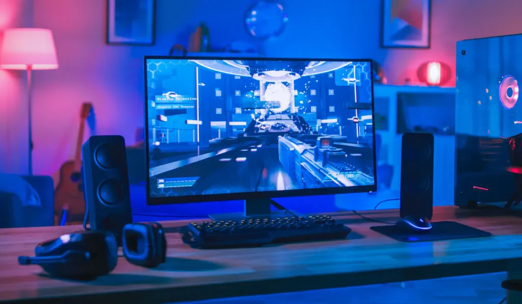 Gaming computer rig with speakers and led lights in the background