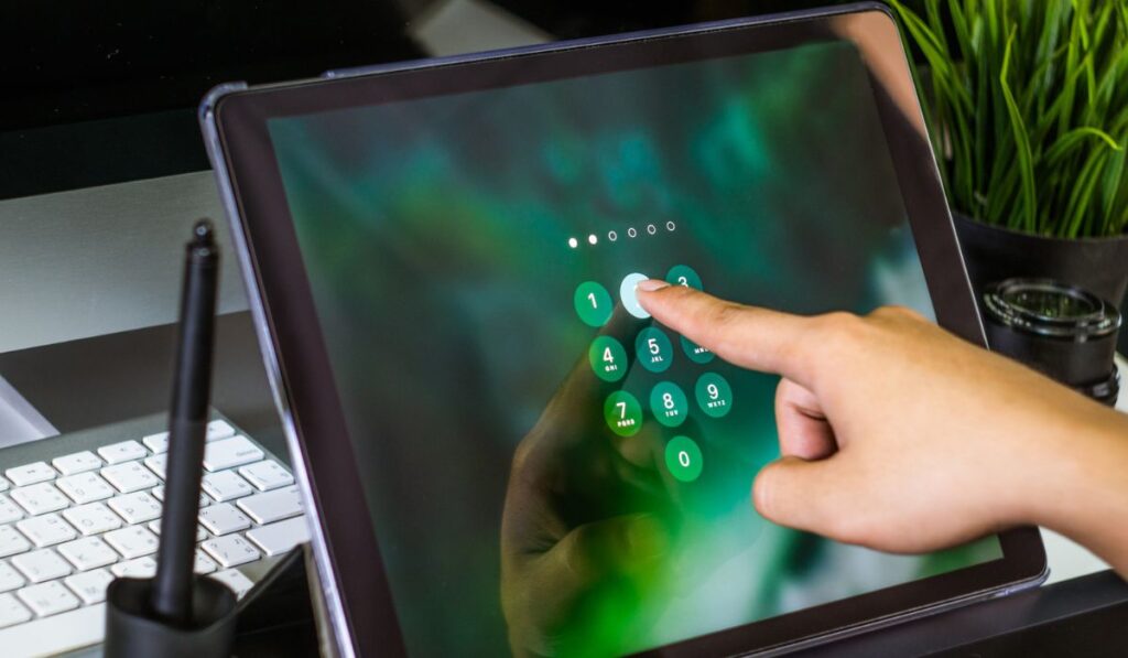 Hand of women tying tablet computer with password login