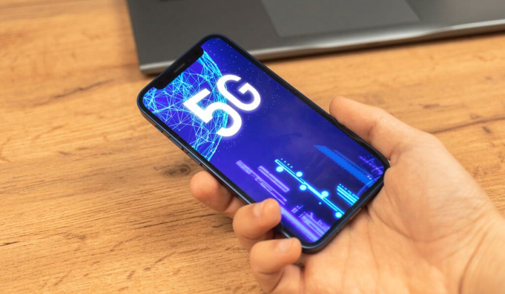 Hand uses mobile phone with 5G network