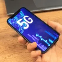 Hand uses mobile phone with 5G network