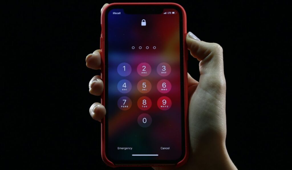 Hand with locked iPhone X