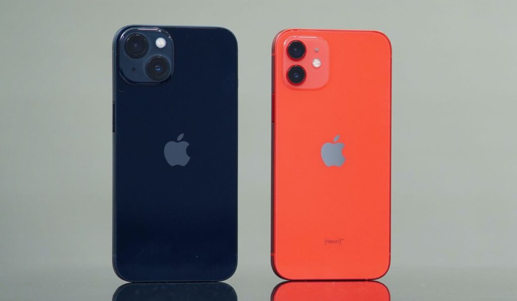 Midnight iPhone 13 and Product Red iPhone 12 standing