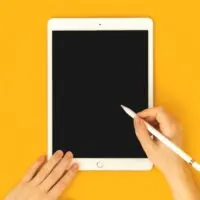Mockup of a woman using digital tablet Apple iPad with pencil stylus pen