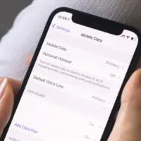 Woman switches mobile data on mobile phone