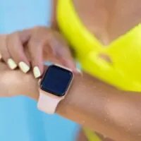 Girl goes out of swimming pool and checks smart watch